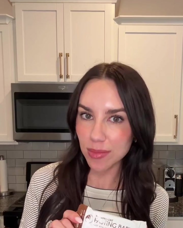 Jennifer Mazonas in her kitchen holding a wrapped Prolon Fasting Bar